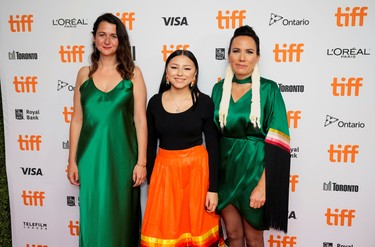 Director Danis Goulet, Producer Tara Woodbury and cast member Brooklyn Letexier-Hart pose at the premiere of the thriller Night Raiders, at the Toronto International Film Festival, Sept. 10, 2021.
