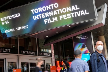 People are seen outside the TIFF Bell Lightbox building, headquarters of the Toronto International Film Festival, in Toronto, Sept. 9, 2021.