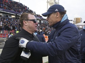 Former Roughriders coach Chris Jones congratulates Argos’ Coach Marc Trestman after a game in 2017.