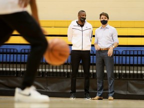 Liberal Prime Minister Justin Trudeau talks with Masai Ujiri, President of Toronto Raptors at the Mattamy Athletic Centre during his election campaign tour in Toronto,  Sept. 1, 2021.