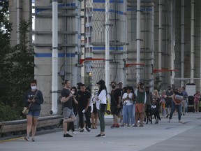 Voters in the Fort York- Spadina riding gather from Forth York to Bathurst St. under The Beltway around 7:30 p.m. with many saying the wait was upwards of two hours. Voters said they used to have 55 polling stations and it was reduced to 15 on Monday September 20, 2021. Jack Boland/Toronto Sun/Postmedia Network