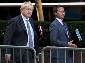 British Prime Minister Boris Johnson walks outside United Nations headquarters during the 76th Session of the UN General Assembly, in New York, Sept. 20, 2021.