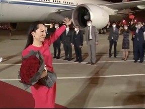 Huawei Technologies Chief Financial Officer Meng Wanzhou waves upon arriving from Canada at Shenzhen Baoan International Airport, in Shenzhen, Guangdong province, China September 25, 2021.