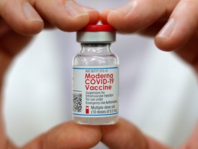 A pharmacist holds a vial of the Moderna COVID-19 vaccine inside a Walmart department store in West Haven, Conn. Feb. 17, 2021.