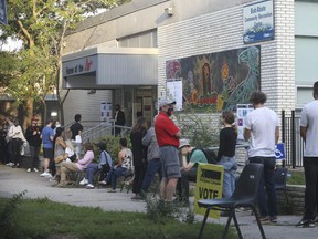 Voters in the University-Rosedale riding wait outside the Bob Abate community Centre on Bloor St. W. to cast their ballots on Monday, September 20, 2021.