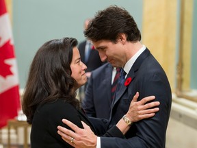 In this file photo taken Nov. 4, 2015, Prime Minister Justin Trudeau speaks with Minister of Justice Jody Wilson-Raybould during a swearing-in ceremony at Rideau Hall in Ottawa.