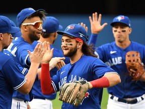 Blue Jays shortstop Bo Bichette celebrates with teammates after defeating the Tampa Bay Rays at the Rogers Centre on Wednesday, Sept. 15, 2021.