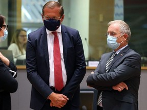 Poland's Interior Minister Mariusz Kaminski (L) and Minister for the Interior of Slovenia Ales Hojs speak during an emergency meeting on the situation in Afghanistan at the European Council, in Brussels, on August 31, 2021.