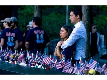 Katie Mascali is comforted by her fiance Andre Jabban as they stand near the name of her father Joseph Mascali, with FDNY Rescue 5, during ceremonies on Sept. 11, 2021, marking the attacks on the World Trade Center in Manhattan.