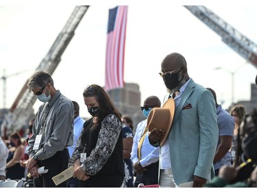 People bow their heads during a remembrance ceremony to mark the 20th anniversary of the 9/11 attacks, at the Pentagon in Washington, D.C. on Sept. 11, 2021.