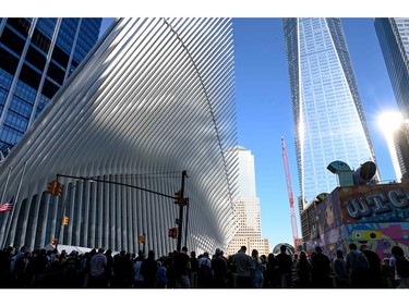A crowd forms near Freedom Tower as they participate in the 20th anniversary of the 9/11 attacks on the World Trade Center near the 9/11 Memorial & Museum in New York, on Sept. 11, 2021.