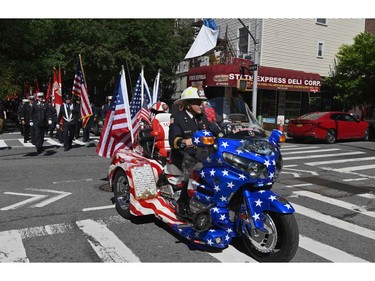 New York firefighters march as they mark the 20th anniversary of the 9/11 attacks on the World Trade Center, in New York, on Sept. 11, 2021.