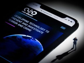 This file studio photographic illustration shows a smartphone with the website of Israel's NSO Group which features 'Pegasus' spyware, on display in Paris on July 21, 2021.