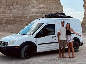Brian Laundrie and Gabby Petito standing outside their white van in front of Monument Rocks.