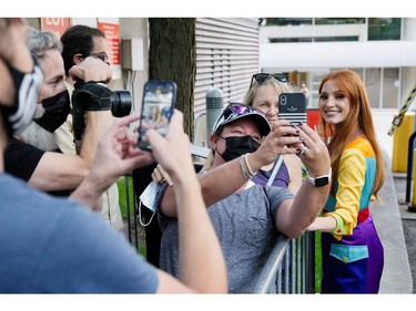 TIFF Tribute Actor Award recipient Jessica Chastain takes a selfie with a fan after a news conference for the 2021 TIFF Tribute Awards during the Toronto International Film Festival in Toronto, Sept. 11, 2021.