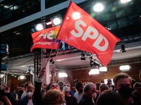 Social Democratic Party (SPD) supporters react after first exit polls for the general elections in Berlin, Germany, September 26, 2021.