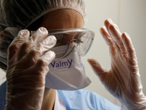A medical worker, wearing protective gear, works in the Intensive Care Unit (ICU) where patients suffering from the coronavirus disease (COVID-19) are treated at Cambrai hospital, France, April 1, 2021.