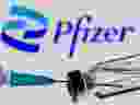 Syringe and vial are seen in front of displayed new Pfizer logo in this illustration taken, June 24, 2021. 