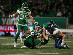 Saskatchewan Roughriders defensive lineman Keion Adams picks up a fumble from Toronto Argonauts quarterback Nick Arbuckle during a CFL football game at Mosaic Stadium in Regina, Saskatchewan on Sept. 17, 2021.