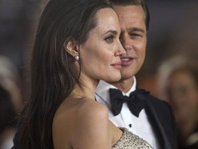 Director and cast member Angelina Jolie and her husband and co-star Brad Pitt pose at the premiere of "By the Sea" during the opening night of AFI FEST 2015 in Hollywood, California November 5, 2015.
