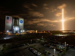 With a view of the iconic Vehicle Assembly Building at left, a SpaceX Falcon 9 rocket soars upward from Launch Complex 39A carrying the company's Crew Dragon Endeavour capsule and four Crew-2 astronauts towards the International Space Station at NASA's Kennedy Space Center in Cape Canaveral, Florida, U.S. April 23, 2021. Picture taken April 23, 2021.    NASA/Ben Smegelsky/Handout via REUTERS.   MANDATORY CREDIT. THIS IMAGE HAS BEEN SUPPLIED BY A THIRD PARTY./File Photo