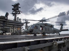 An MH-60S Sea Hawk helicopter conducts flight control checks on the flight deck of the U.S. Navy aircraft carrier USS Nimitz in the Indian Ocean November 25, 2020. Picture taken November 25, 2020.