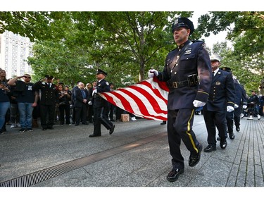 Members of the NYPD carry a frayed American Flag during a ceremony marking the 20th anniversary of the Sept. 11, 2001 attacks in New York City, Sept. 11, 2021.