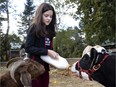 Zoe Serrati feeds Olive, a calf she and her father rescued and brought to Monkey Spaces, an animal sanctuary near St-Jérôme.