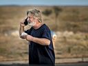 Alec Baldwin speaks on the phone in the parking lot outside the Santa Fe County Sheriff's Office in Santa Fe, N.M., after he was questioned about a shooting on the set of the film