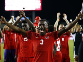 Samuel Adekuge (No. 3) of Canada celebrates with teammates and fans following the final whistle of a 2022 World Cup Qualifying match against Panama at BMO Field on October 13, 2021 in Toronto.