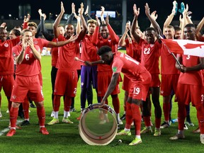 Alphonso Davies #19 of Canada bangs a supporters drum following the final whistle of a 2022 World Cup Qualifying match against Panama at BMO Field on October 13, 2021 in Toronto.