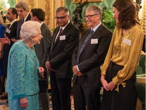 Britain's Queen Elizabeth II (L) greets guests including Microsoft founder-turned-philanthropist Bill Gates (2R) during a reception to mark the Global Investment Summit, at Windsor Castle in Windsor, west of London on October 19, 2021.