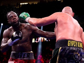 Tyson Fury (R) exchanges punches with Deontay Wilder during their WBC heavyweight title fight at T-Mobile Arena on October 09, 2021 in Las Vegas, Nevada.