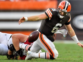 Baker Mayfield #6 of the Cleveland Browns fumbles the ball after a tackle from J.J. Watt #99 of the Arizona Cardinals during the third quarter at FirstEnergy Stadium