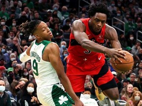 Romeo Langford of the Boston Celtics fouls OG Anunoby of the Toronto Raptors during the Celtics home opener at TD Garden on October 22, 2021 in Boston, Massachusetts.