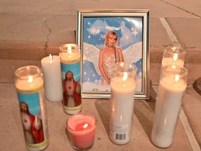 Candles are placed around a photo of cinematographer Halyna Hutchins during a vigil held in her honour at Albuquerque Civic Plaza in Albuquerque, New Mexico, Oct. 23, 2021.