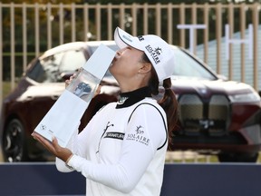 Jin Young Ko of Korea Republic kisses the winner's trophy after the final round of the BMW Ladies Championship at LPGA International Busan on October 24, 2021 in Busan, South Korea.