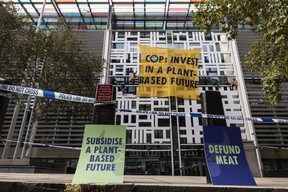 Environmental activists scale the Home Office on October 26, 2021 in London, England. Protesters dropped a banner from the building reading “COP: Invest In A Plant-Based Future,” referring to the upcoming United Nations Conference On Climate Change (COP26) in Glasgow. (Dan Kitwood/Getty Images)