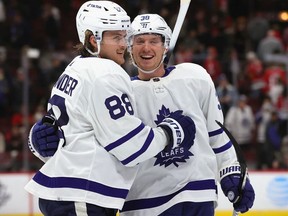 William Nylander of the Toronto Maple Leafs celebrates getting the game-winning goal in overtime against the Chicago Blackhawks with teammate Rasmus Sandin at the United Center on October 27, 2021 in Chicago, Illinois.