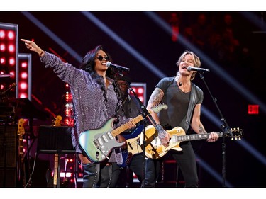 H.E.R. and Keith Urban perform onstage during the 36th Annual Rock & Roll Hall Of Fame Induction Ceremony at Rocket Mortgage Fieldhouse on Oct. 30, 2021 in Cleveland, Ohio.