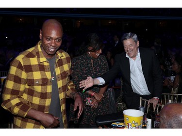 Dave Chappelle, Nicole Avant, and Ted Sarandos speak backstage during the 36th Annual Rock & Roll Hall Of Fame Induction Ceremony at Rocket Mortgage Fieldhouse on Oct. 30, 2021 in Cleveland, Ohio.