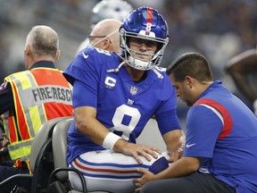 New York Giants quarterback Daniel Jones leaves the field on a cart with an injury in the second quarter against the Dallas Cowboys.