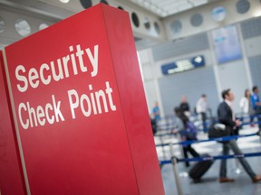 A sign directs travellers to a security checkpoint staffed by Transportation Security Administration (TSA) workers at O'Hare Airport in Chicago, Illinois.