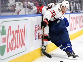 Senators' Connor Brown (28) is bodychecked by Toronto Maple Leafs defenceman Jake Muzzin in a pre-season game.