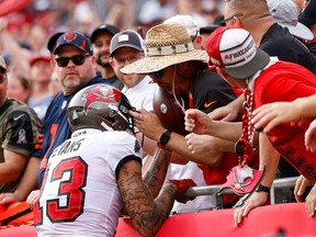 Tampa Bay Buccaneers wide receiver Mike Evans (13) unknowingly gives away quarterback Tom Brady’s (12) (not pictured) 600 touchdown pass ball to a fan in the first half against the Chicago Bears at Raymond James Stadium Oct. 24, 2021.