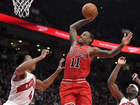 Chicago Bulls guard DeMar DeRozan (11) goes to the basket over Toronto Raptors forwards Scottie Barnes (4) and Precious Achiuwa (5) in the second half at Scotiabank Arena on Oct. 25, 2021.