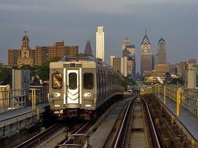 A SEPTA train on the Market-Frankford rapid transit line with the Philadelphia skyline in the background.