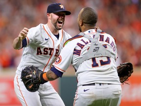 Ryan Pressly of the Houston Astros celebrates with Martin Maldonado after the final out in the ninth inning as they defeat the Boston Red Sox 5-0 in Game Six of the American League Championship Series on October 22, 2021 in Houston, Texas.