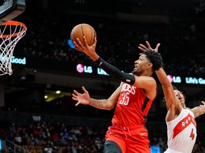 Houston Rockets' Christian Wood drives to the basket against Raptors' Scottie Barnes during the first half at Scotiabank Arena on Monday, Oct. 11, 2021.