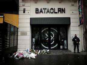 A French policeman stands guard in front of the Bataclan concert venue during a ceremony marking the fifth anniversary of the deadly terror attacks in Paris, France, November 13, 2020.